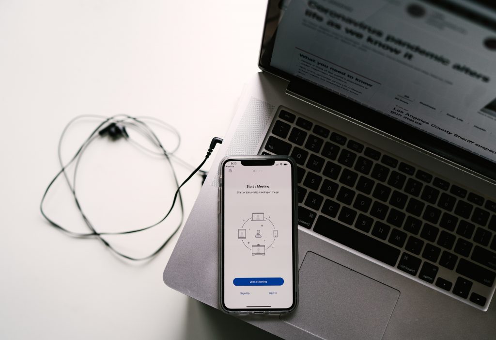 image of laptop and phone ready to dial in to a meeting